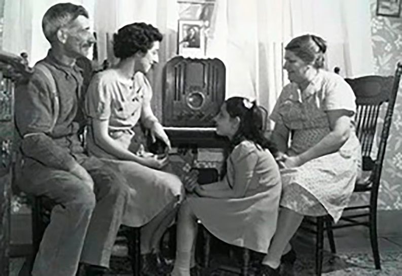 Familia de inicios del siglo XX oyendo radio