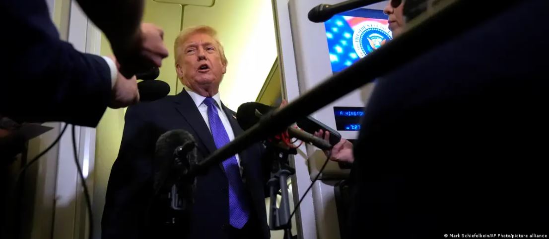 Trump speaks with the press aboard Air Force One. 