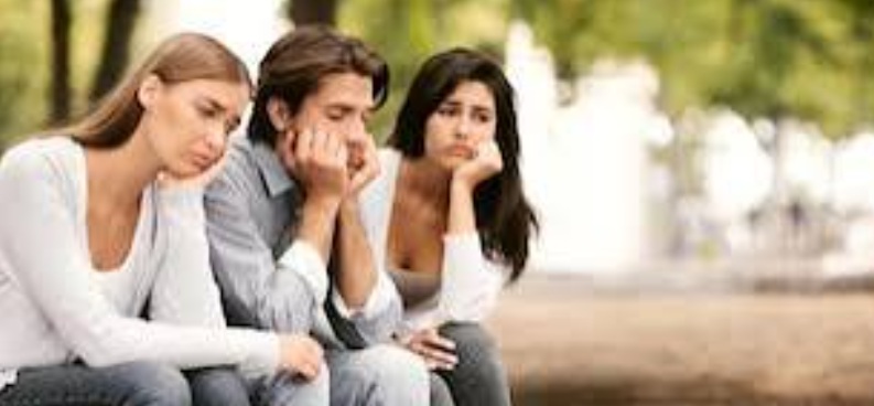 Inactive young people sitting in a park