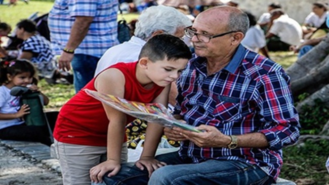 Grandfather sharing a reading with grandson Grandfather sharing a reading with grandson